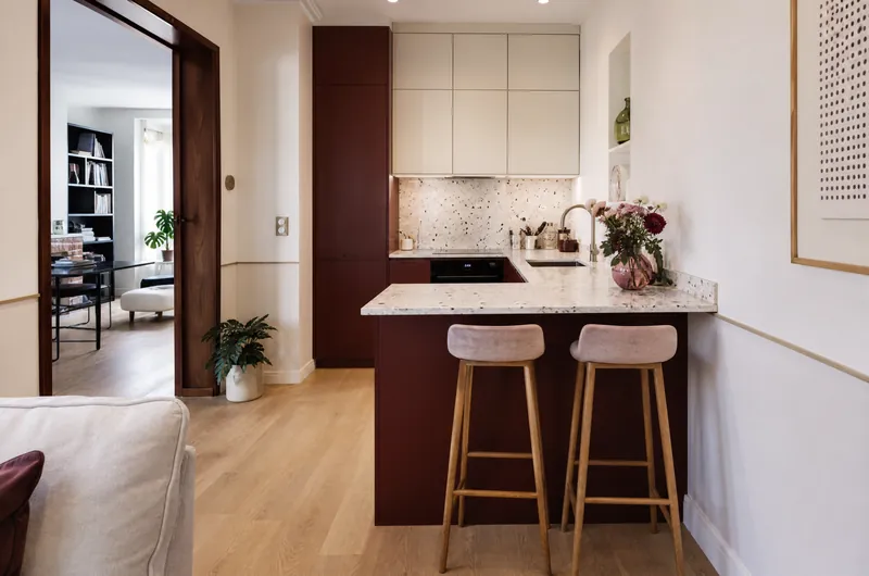 Petite cuisine avec péninsule fixée au mur, ouverte sur le séjour